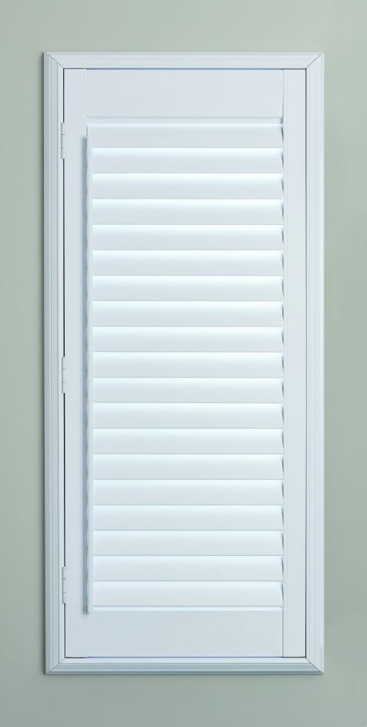 Full-height plantation shutters with louvres tilted for filtered light