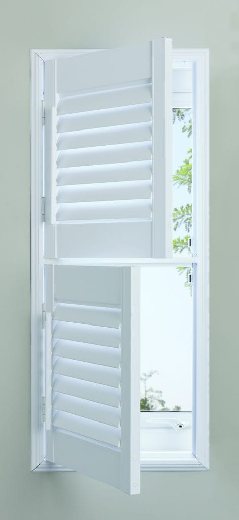 Tier-on-tier plantation shutters with top panels open and bottom panels closed for privacy