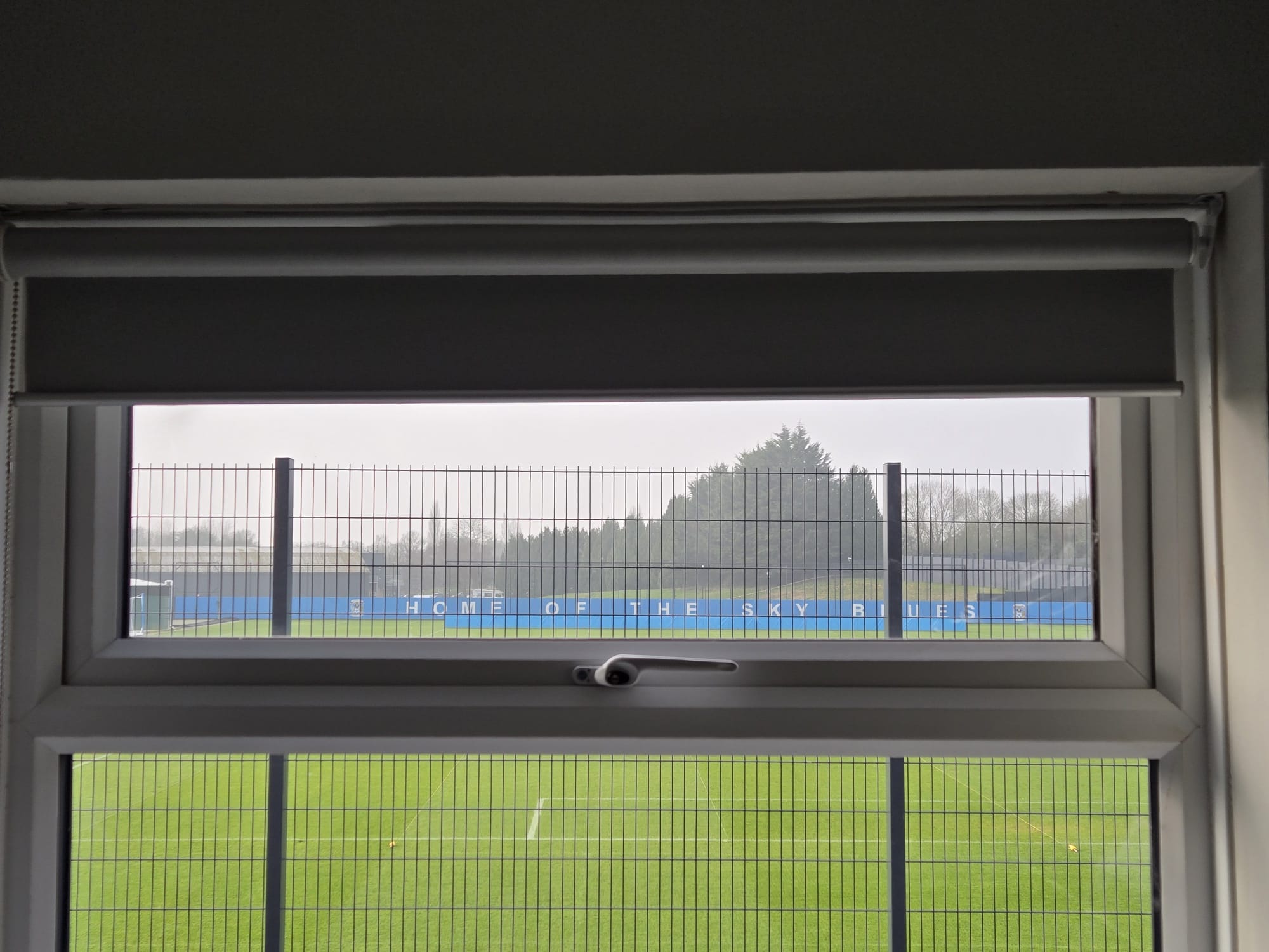 Grey roller blind at Coventry City FC training ground with pitch view